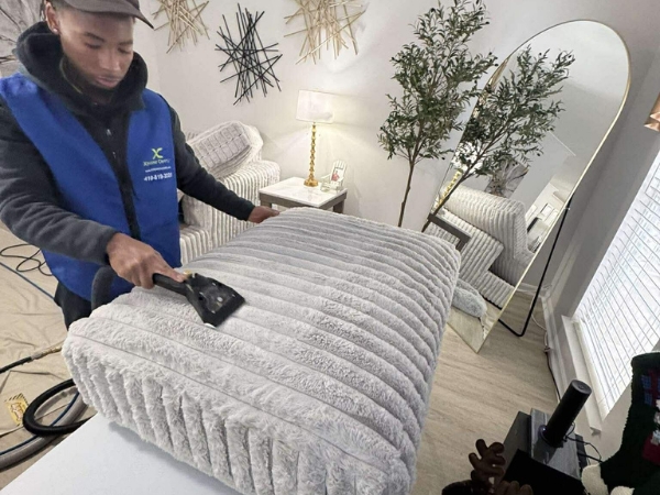 Xtreme Cleans technician performing upholstery cleaning in Baltimore MD